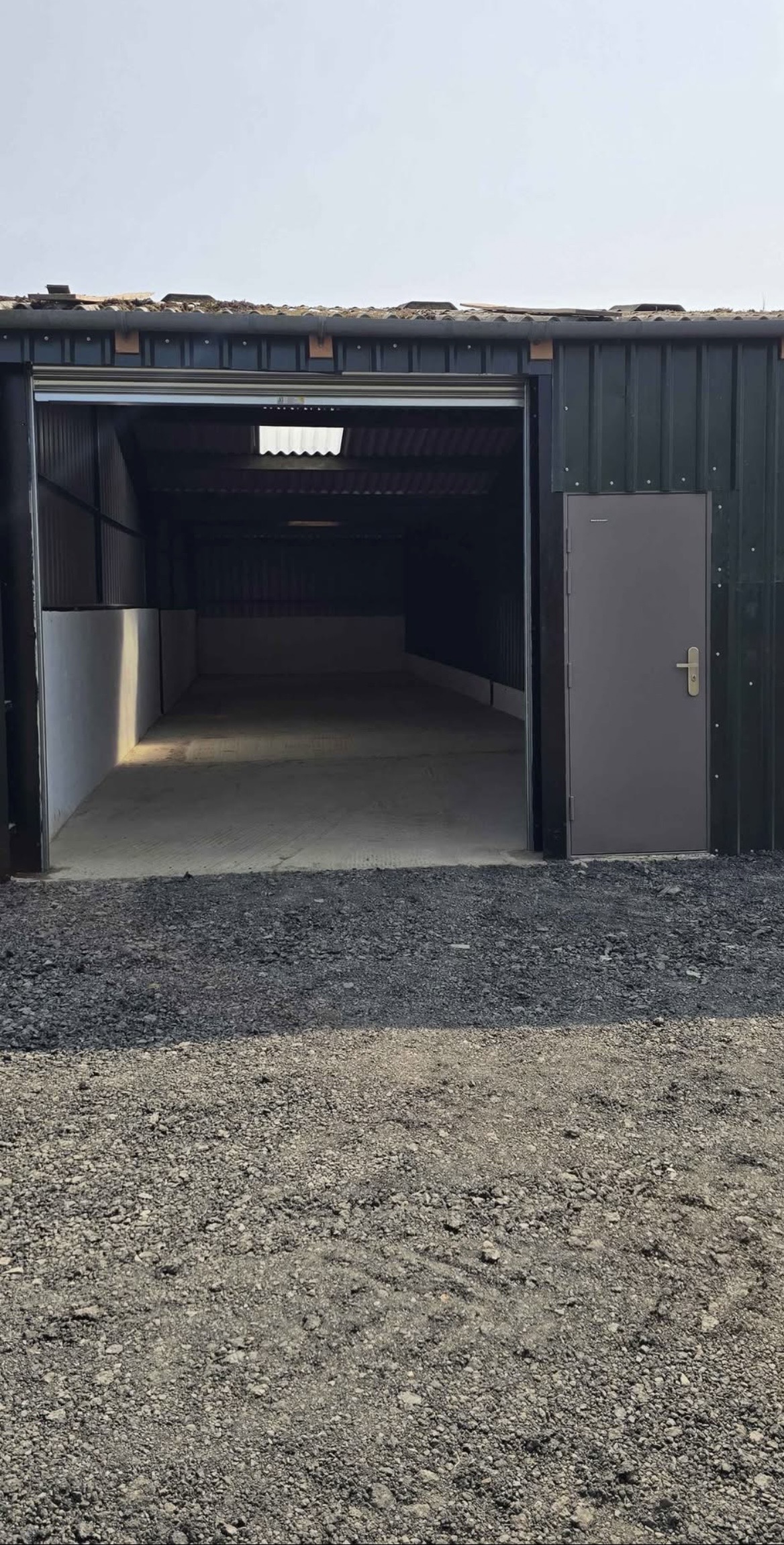 Open roller shutter and separate pedestrian entrance to a Summerton storage unit