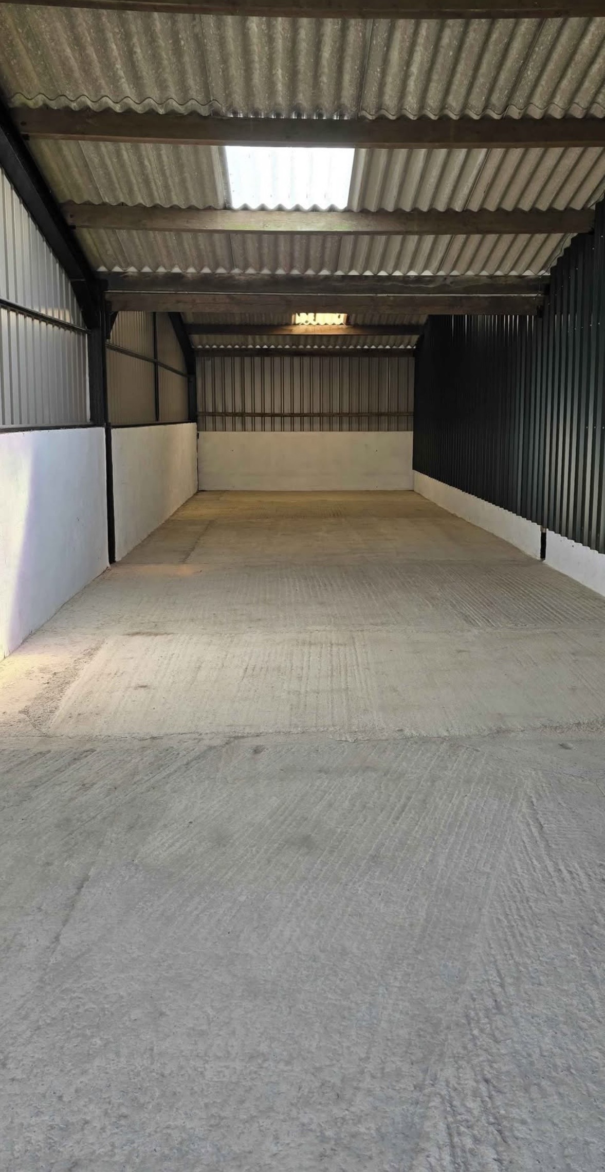 View along the empty storage unit towards the rear wall